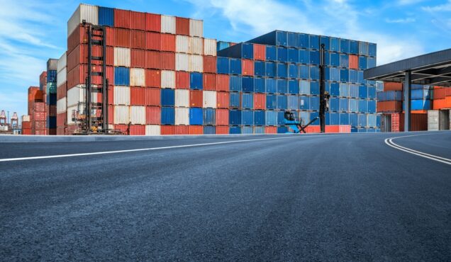 Stacked,Containers,And,Empty,Asphalt,Road,At,The,Port